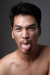 Fototapeta premium Asian man portrait with no makeup show his real skin in grey background - soft focus