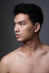 Asian man portrait with no makeup show his real skin in grey background - soft focus - 106301711