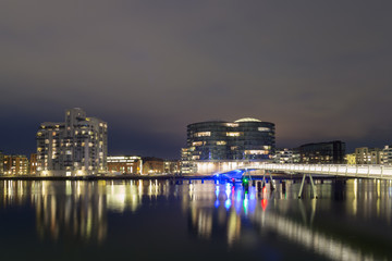 Modern cyclist bridge and Gemini Residence in Copenhagen by night