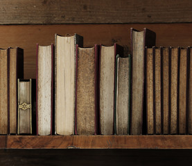 old books on wooden shelf.