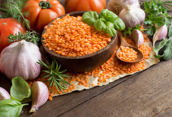 Red lentils in a bowl with tomatoes, garlic and herbs