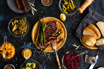 BBQ Beef steak with pickled veggies, cucumber, cabbage, beeroot, marinated pepper. Dinner party. - obrazy, fototapety, plakaty