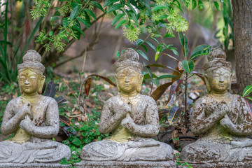 old Buddha stone statue in the Wat Thailand