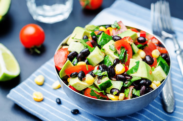 Black beans corn avocado cucumber tomato salad with lime dressin