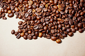 Macro:  fried coffee beans on brown paper