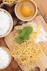 Making noodle with wheat flour and egg for cooking.