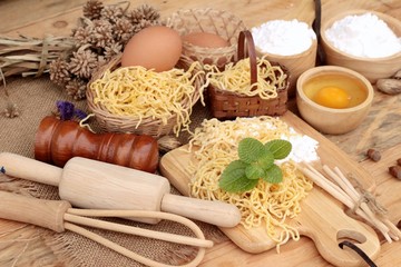 Making noodle with wheat flour and egg for cooking.