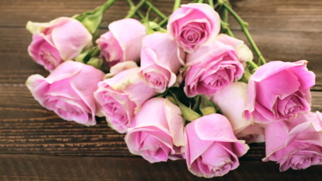 Pink roses on rustic wood table