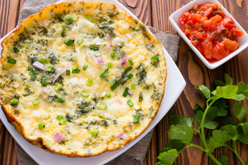 omelette, parsley and stewed tomatoes with fennel on the wooden background