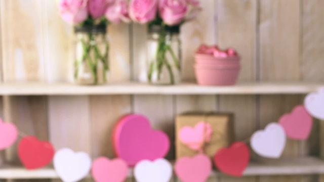 Bouquet with pink roses in mason jar on wood shelf