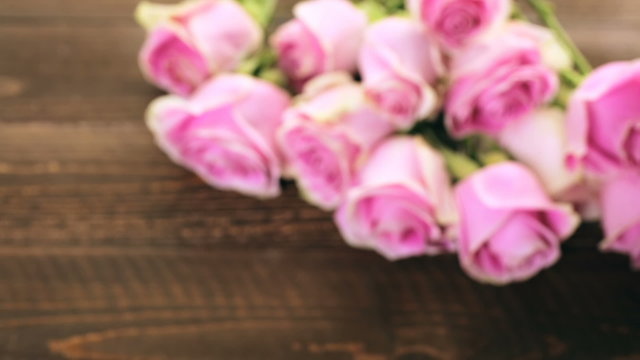 Pink roses on rustic wood table
