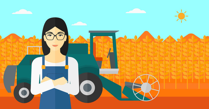 Woman standing with combine on background.