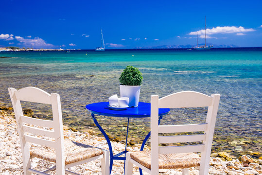 Fototapeta Cute little tavern on the sea coast in Paros island, cycladic paradise resort, Cyclades, Greece