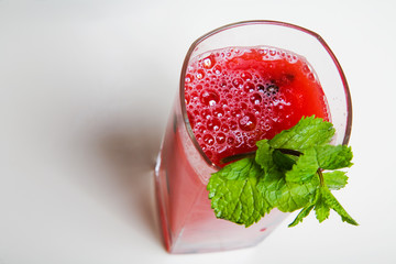 glass of fresh watermelon juice with mint leaves