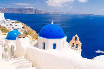 White architecture and blue dome churches in Oia, Santorini, Greece - 106315381