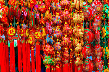 Various of Chinese red decorations hanging for sell at the market. With greeting word wish you have a good year, good health, good luck and rich.