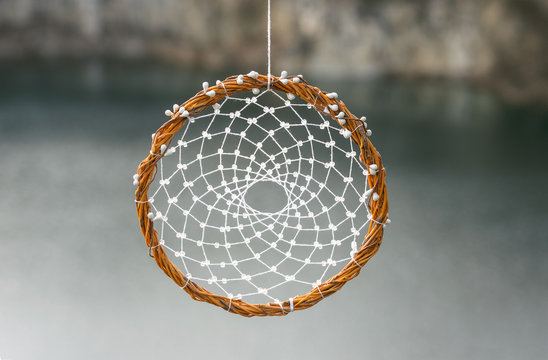 Handmade Dream Catcher On Background Of Rocks And Lake