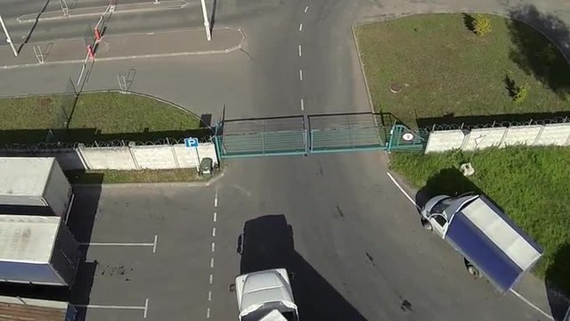 The truck drives through a sliding gate