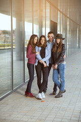 Happy teen girls and boys having good fun time outdoors. Selecti