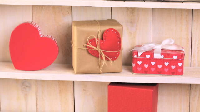 Pink roses in jars and gifts on rustic wood shelf for Valentines DAy
