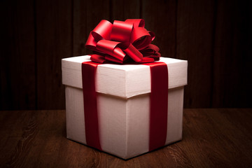 one large white gift box on a wood