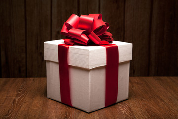 one large white gift box on a wood