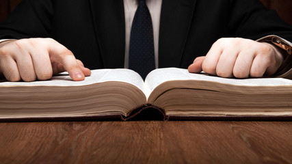 man is looking for information in the dictionary