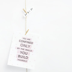 Simple garland with postcard on the white wall.  Minimalistic, simple, cute hipster scandinavian home interior decoration
