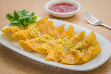 Deep fried dumplings on plate and dipping sauce