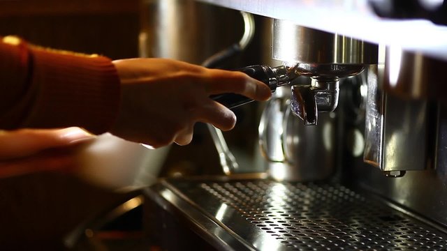 Detail of an espresso making machine and a cup.