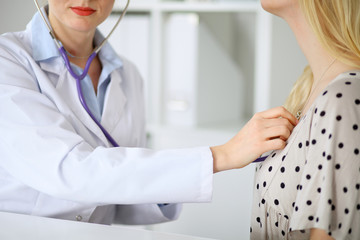 doctor examines a patient with a stethoscope