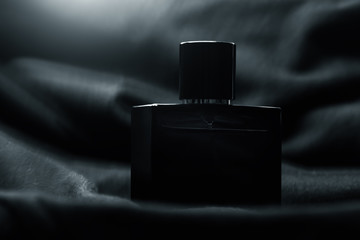 Bottle of men perfume and gray scarf