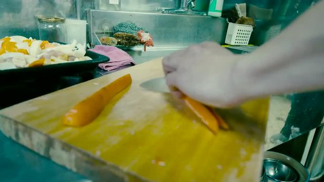 Slicing Orange Carrots on a Cutting Board