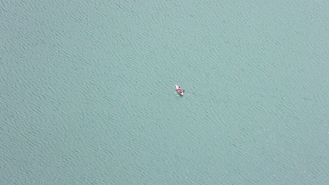 Capture stunning aerial still shots of canoes gliding across the serene lake,perfect for showcasing the beauty of nature and outdoor adventures.
