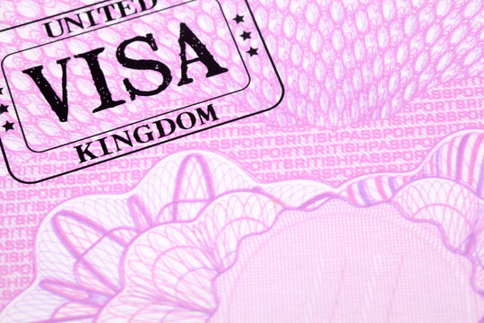 UK united kingdom visa immigration rubber stamp on British passport page photo