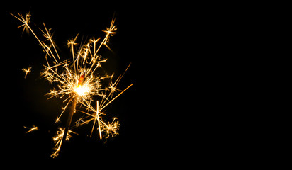 Christmas sparkler on black background. Bengal fire