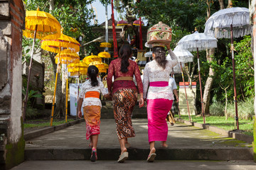 Women walks up the stairs during the celebration before Nyepi (Balinese Day of Silence). Ubud,...
