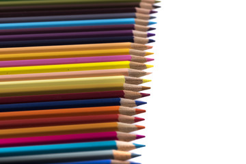 colored pencils on a blank sheet of paper, ready to be used in design