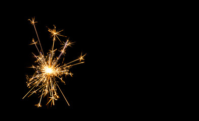 Christmas sparkler on black background. Bengal fire