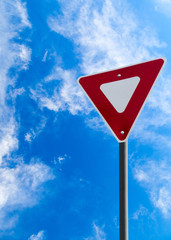 Traffic Yield Sign With Blue Sky Background and Copy Space