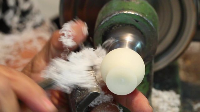 The skilled artisan meticulously shapes their artwork with exceptional precision,showcasing their mastery through the delicate touch of the chisel.