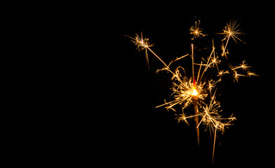 Fototapeta premium Christmas sparkler on black background. Bengal fire