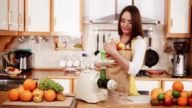 Woman in kitchen preparing fruits for juicing 4K