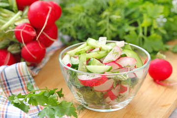 Fresh salad with radishes, cucumbers and olive oil