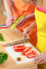 Couple preparing fresh vegetables salad. Diet