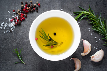 Black food background with olive oil and spices