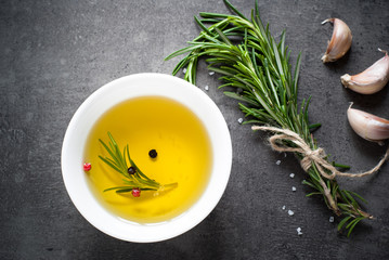 Black food background with olive oil and spices © nadianb