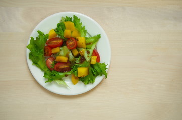 salad in plate on wood background