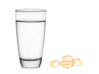 Glass of water and fish oil on white background
