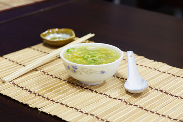 White bowl of cream asparagus soup